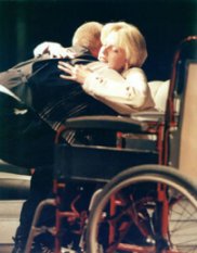 Derek (Fudge Fordyce) helps his wife Helen (Jude Salmon) into her wheelchair as her illness gets worse 